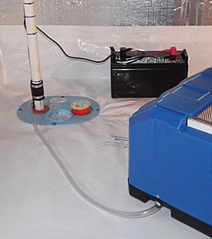 Closeup of a crawl space sump pump installed in Owego