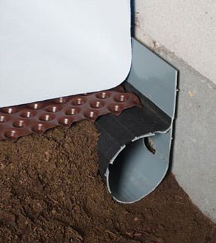 Closeup of a crawl space drainage system installed in Willet