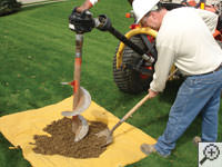 Auguring a hole in the earth for a foundation repair in Windsor