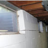 A foundation showing severe inward buckling along the windows in a Port Crane home.