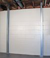 A steel i-beam system installed on a Spencer foundation wall
