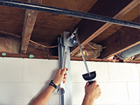 Straightening a foundation wall with the PowerBrace™ i-beam system in a Lansing home.