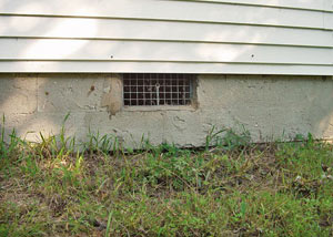 Open crawl space vents that let rodents, termites, and other pests in a home in Walton