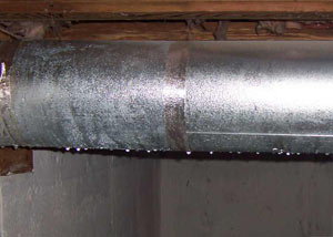 condensation collecting on an HVAC vent in a humid Windsor basement