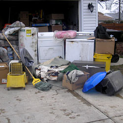 Soaked, wet personal items sitting in a driveway, including a washer and dryer in Horseheads.