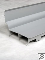 wall flange designed to direct water to a French drain system