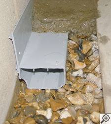 A no-clog basement french drain system installed in Conklin
