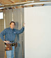 Installing wall panels on top of our basement wall insulation in Horseheads