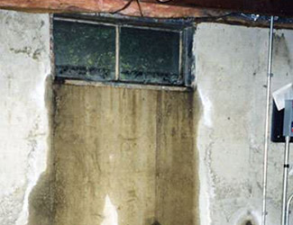Water pouring out from a basement window in Johnson City