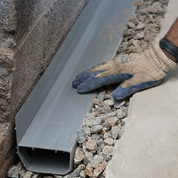 installing a drain tile system in a Delhi home